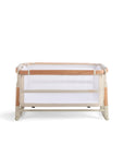 Cutout view of the CoZee bassinet in Scandi finish, shown in rocking mode with mesh panels and curved legs for gentle soothing