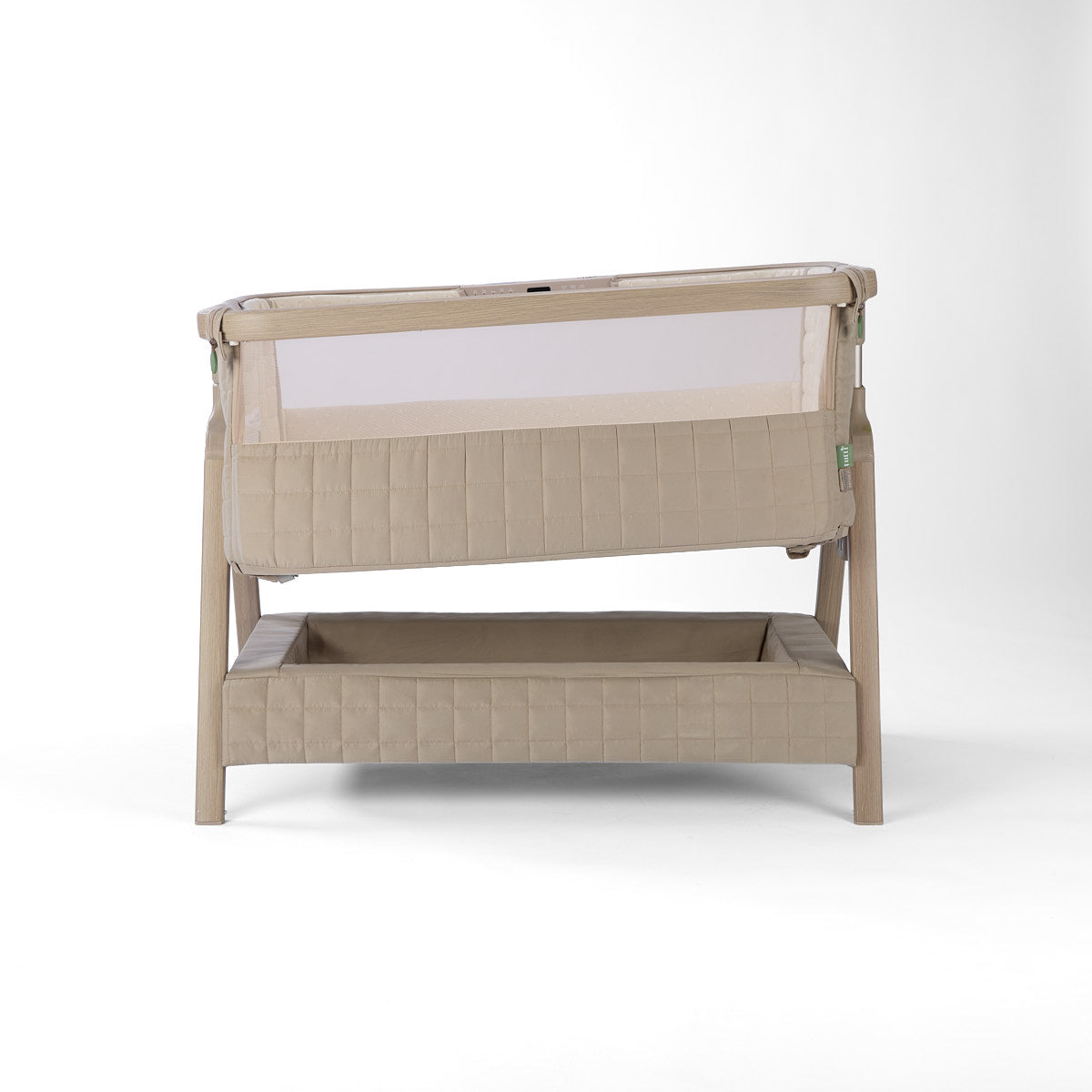 CoZee Sense beige baby crib with mesh and quilted lining sides, storage, incline option and sensory bar on a white background