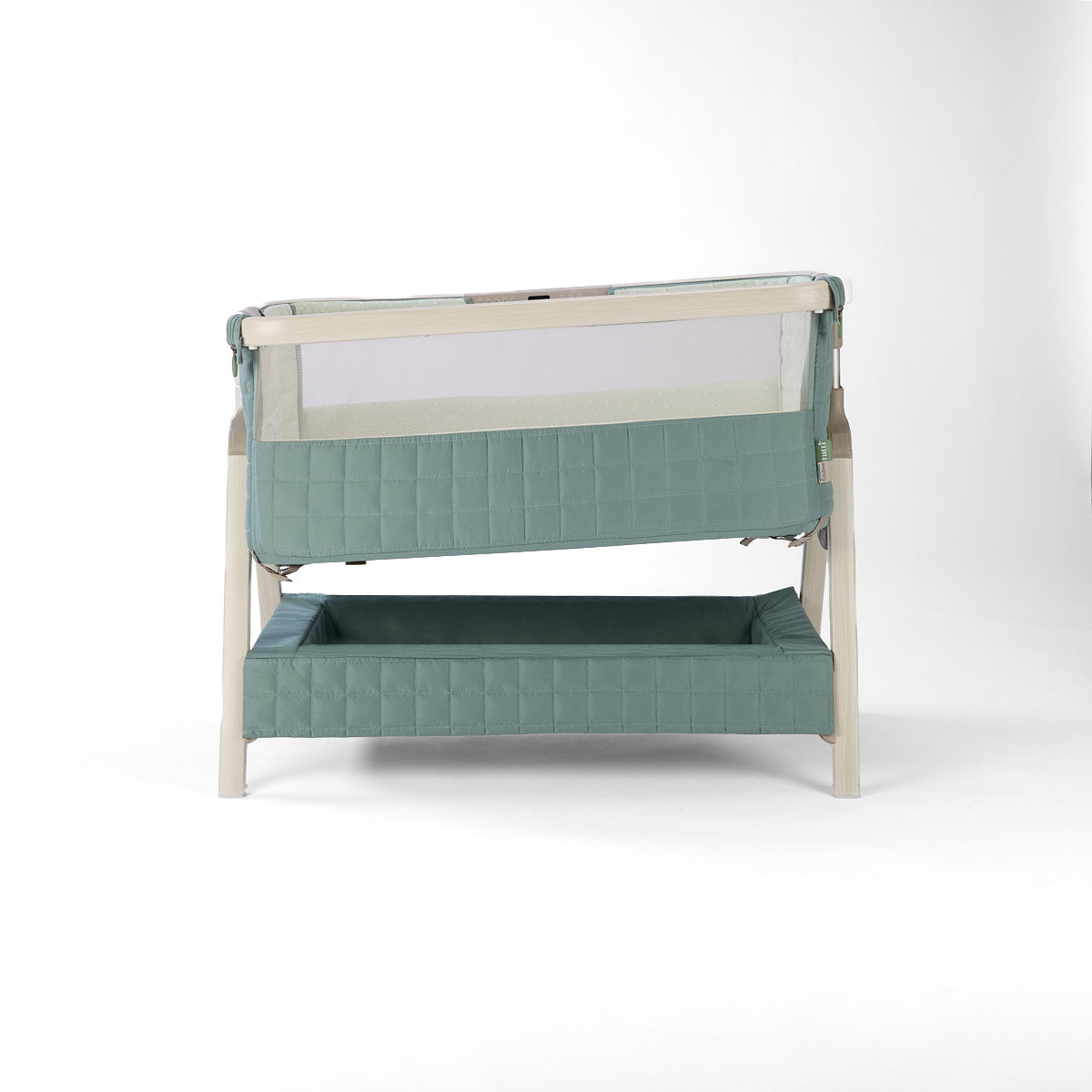 CoZee Sense green baby crib with mesh and quilted lining sides, incline option, storage and sensory bar on a white background
