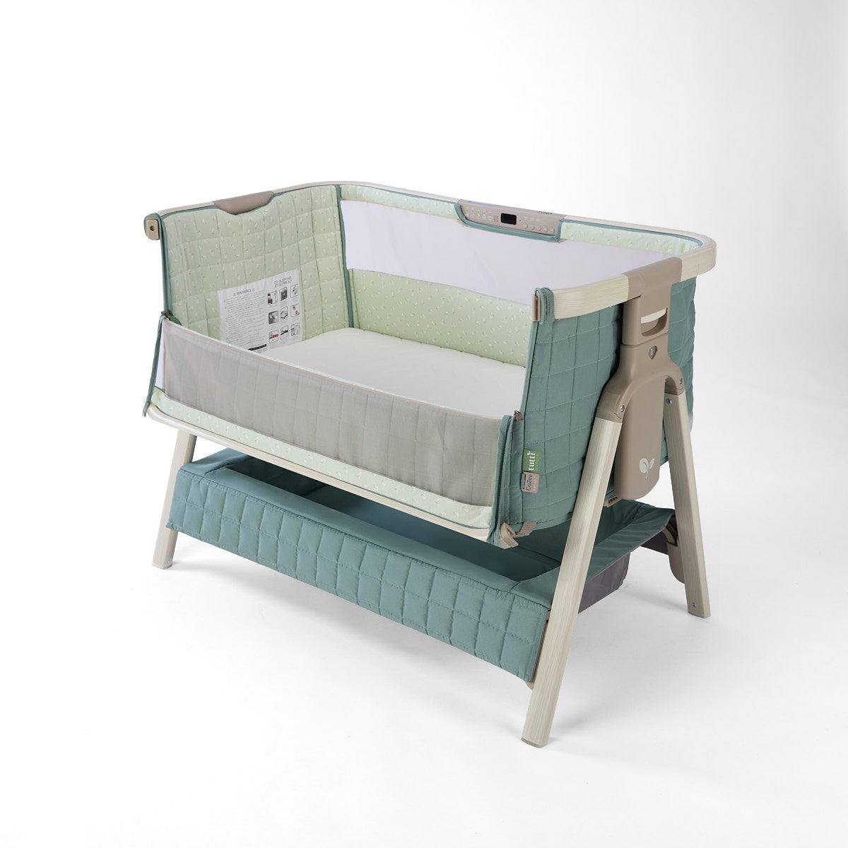 CoZee Sense green baby crib with mesh and quilted lining open side, storage and sensory bar on a white background