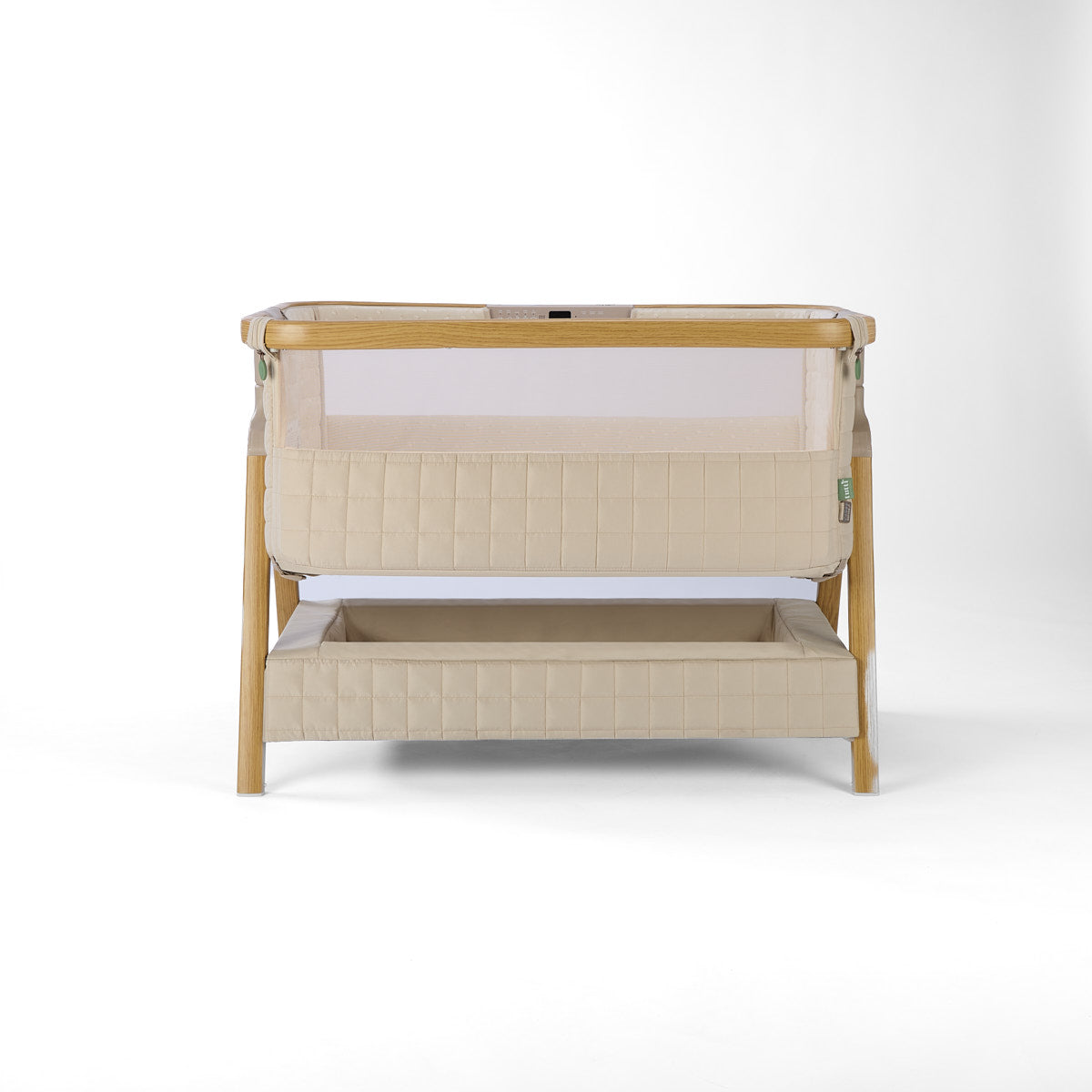 CoZee Sense beige baby crib with mesh and quilted lining sides, storage and sensory bar on a white background