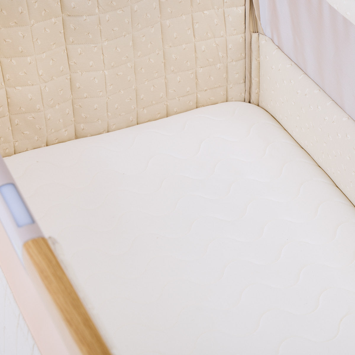 Inside of CoZee Sense with beige and leaves walls and white sheets