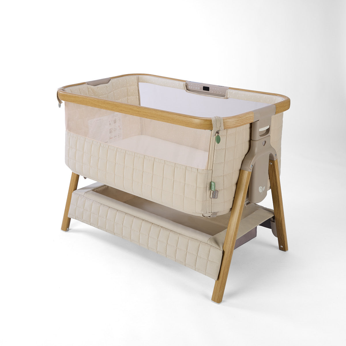 CoZee Sense beige baby crib with mesh and quilted lining sides, storage and sensory bar on a white background