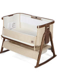 CoZee Sense in rich walnut and quilted cashmere crib with mesh and quilted lining sides, storage and sensory bar on a white background.