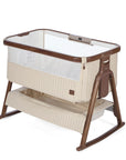 CoZee Sense in rich walnut and quilted cashmere crib with mesh and quilted lining sides, storage and sensory bar on a white background.