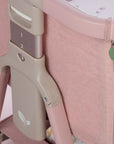 Close-up of CoZee Zen pink crib with adjustable height settings on a light background