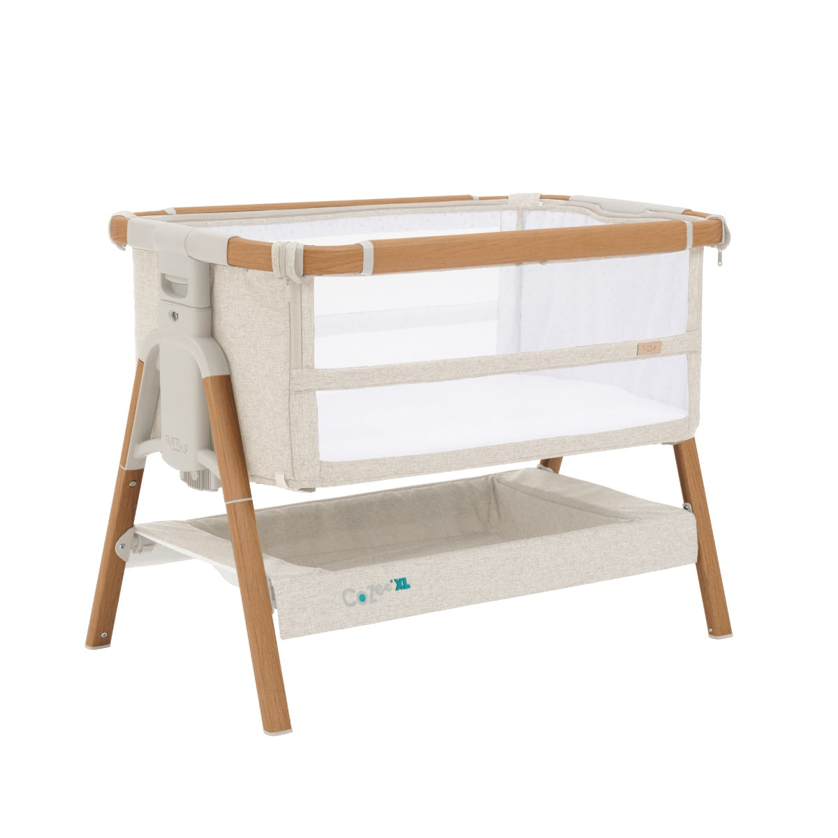 Angled cutout view of the CoZee XL bedside crib in Scandinavian walnut and ecru with mesh sides, storage shelf, and adjustable height frame