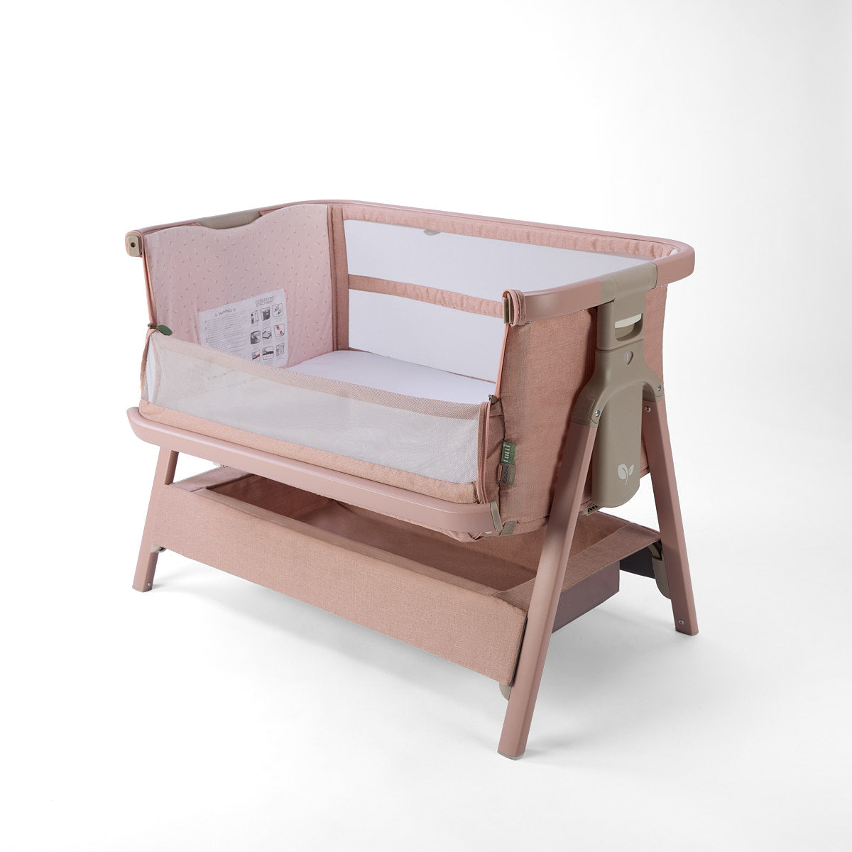 CoZee Zen pink baby crib with open side and white mattress on a white background