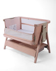CoZee Zen pink baby crib with open side and white mattress on a white background