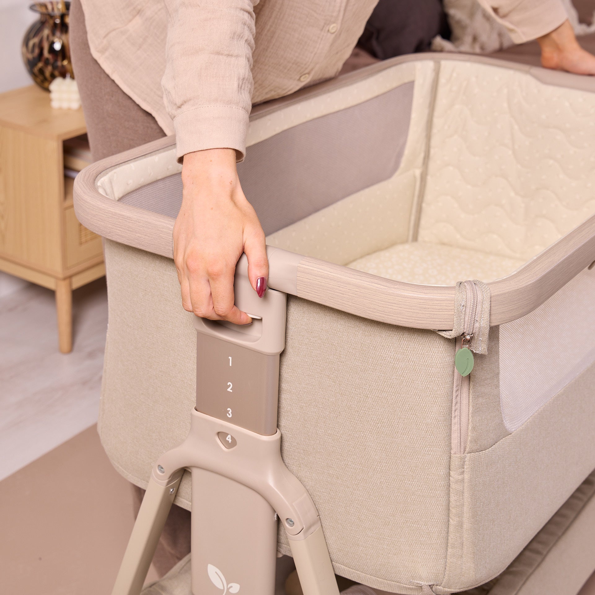 Close-up of the CoZee Air 2 in cocoa showing height-adjustable frame with easy-to-use settings for a secure, bedside fit.