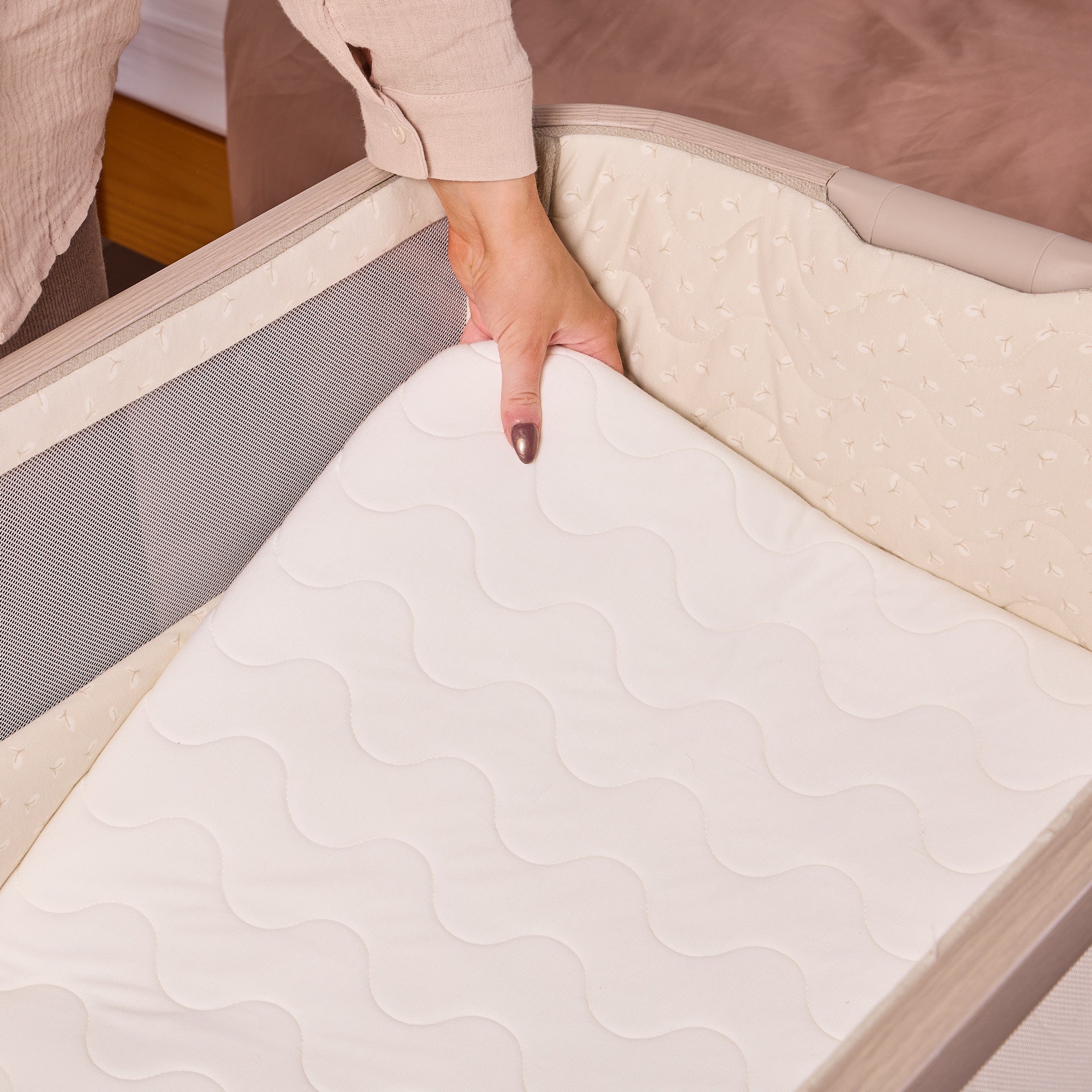 Close-up of the CoZee Air 2 in cocoa mattress being lifted to highlight the breathable, supportive sleep surface and removable inner mattress.
