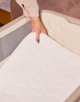 Close-up of the CoZee Air 2 in cocoa mattress being lifted to highlight the breathable, supportive sleep surface and removable inner mattress.
