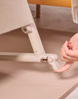 cozee air 2 in cocoa showing lockable safety brakes for when you want to keep your bedside crib stationary.