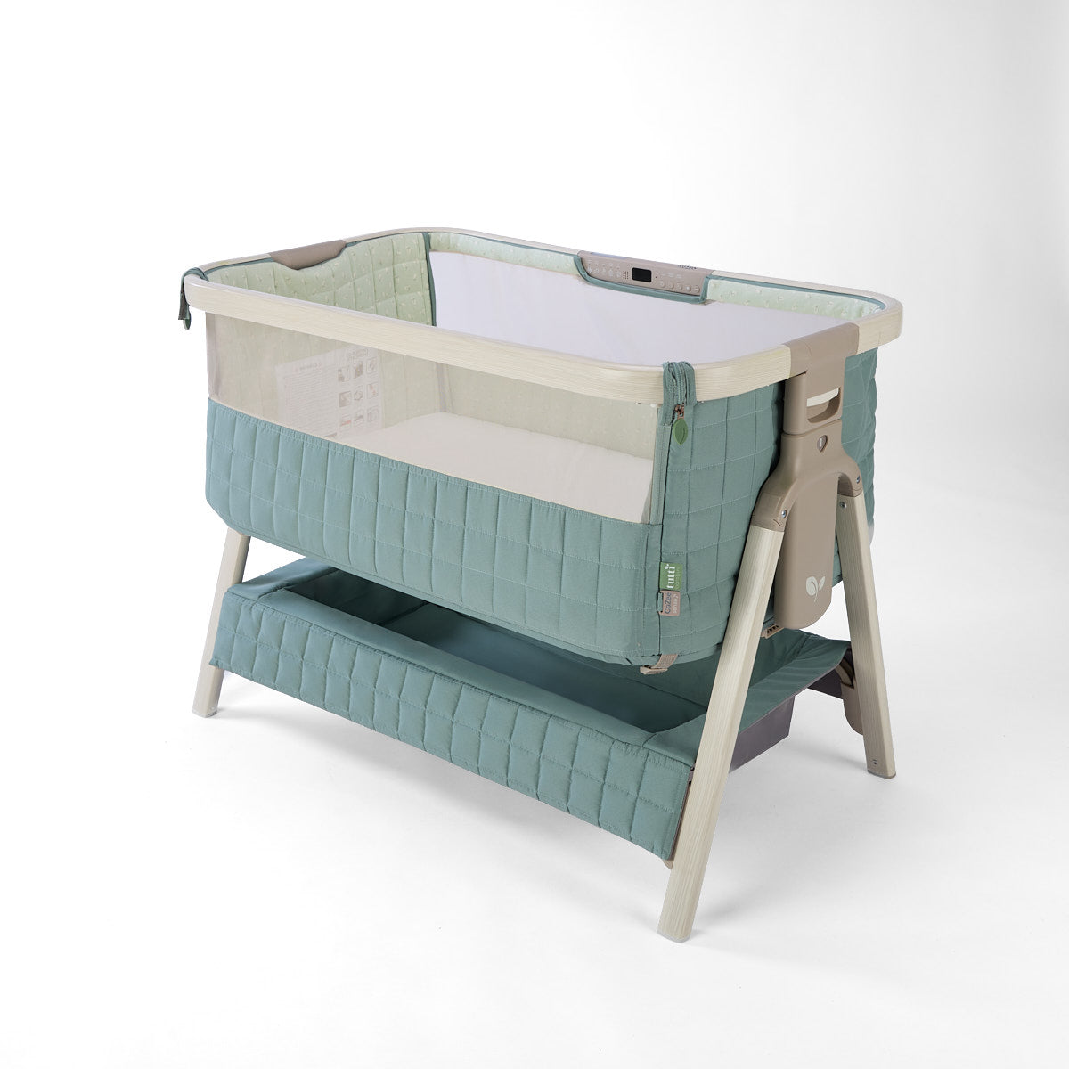 CoZee Sense green baby crib with mesh and quilted lining sides, storage and sensory bar on a white background