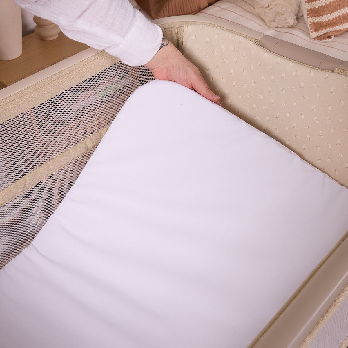 Close-up of the CoZee Zen in sand mattress being removed, demonstrating the easy-clean design and supportive padded surface.