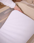 Close-up of the CoZee Zen in sand mattress being removed, demonstrating the easy-clean design and supportive padded surface.
