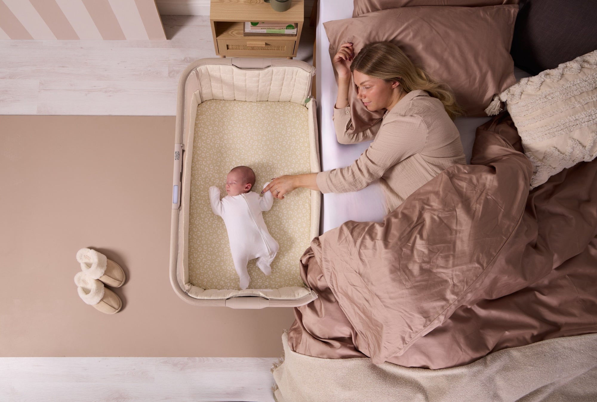Woman interacting with a baby in a crib in a bedroom setting