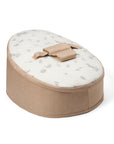 A beige baby beanbag chair featuring frolicking bunnies and delicate leaves.