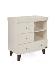 A side view of the Como chest changer in cashmere with a removable changing top, three drawers and open shelving for organised nursery storage.