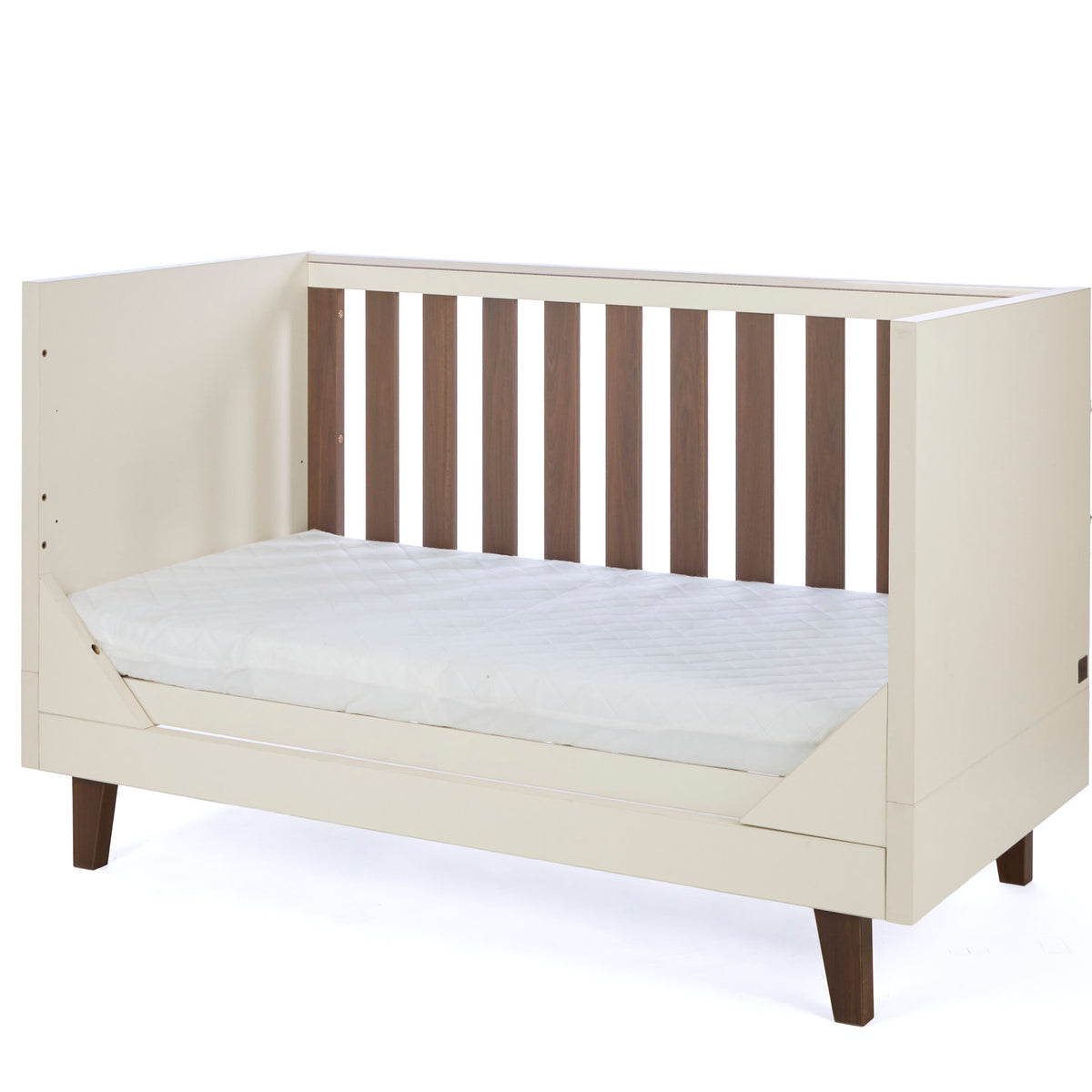 An angle view of the Como sofa bed in cashmere and rich walnut, featuring open sides and slatted back for a stylish and versatile nursery option.