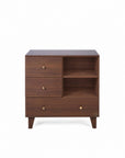 A front view of the Como chest changer in walnut with three drawers and open shelving for organised nursery storage.