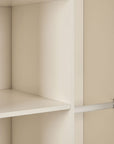 A close up view inside a nursery wardrobe featuring a shelf and metal hanging rail.