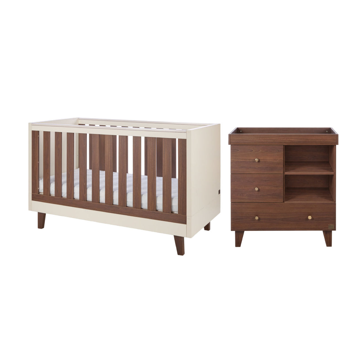 A cot bed and changing table set in cream and matching dark brown walnut wood, shown on a plain white background.