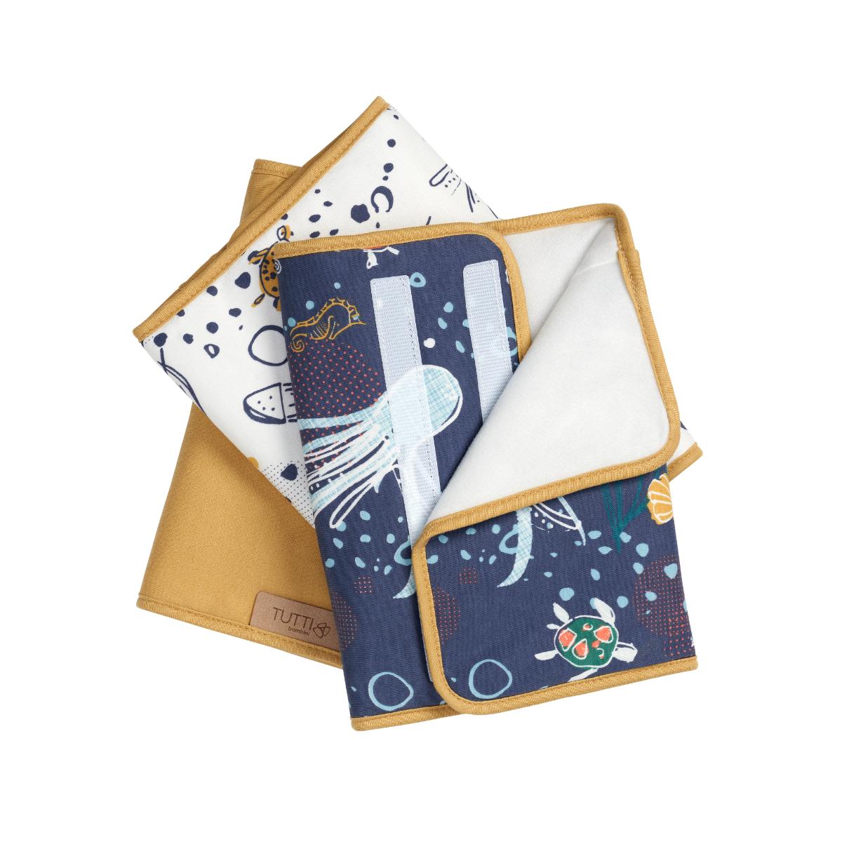Stacked view of the Our Planet cot wraps set, featuring ocean-inspired prints and mustard trims, designed to protect cot rails during teething