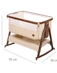 An infographic of a baby bedside crib with a brown frame and beige striped fabric, shown on a white background with dimension lines and text indicating height, width, and depth.