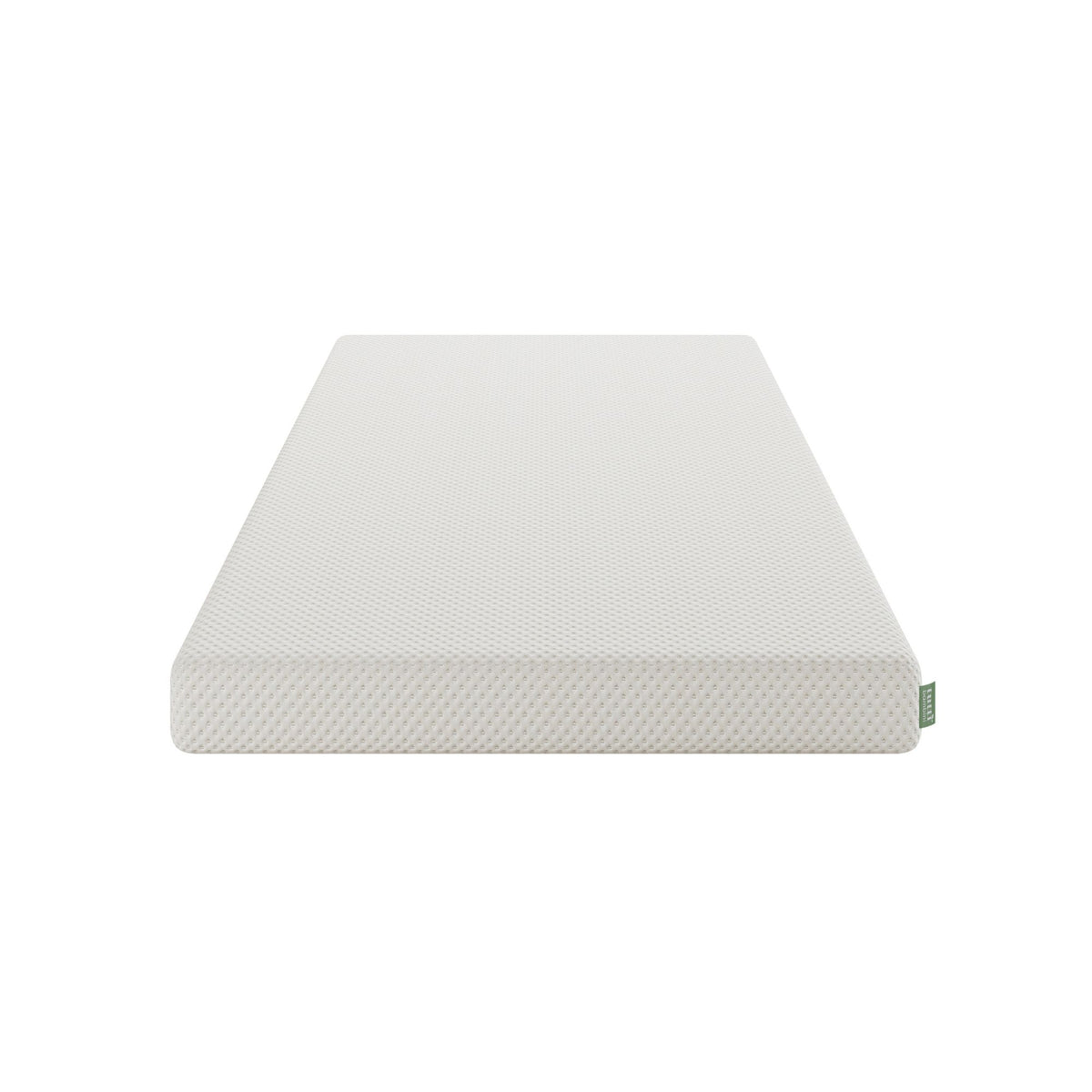 A white textured junior mattress layer shown at an angle on a solid white background, featuring a small green tag on the corner.