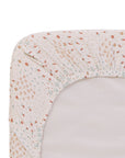 Close-up of the Good Life crib sheet with a nature-inspired pattern on a white background