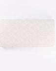 Good Life cot bed fitted sheet in delicate pastel print, displayed flat to highlight breathable cotton fabric and elasticated edges.