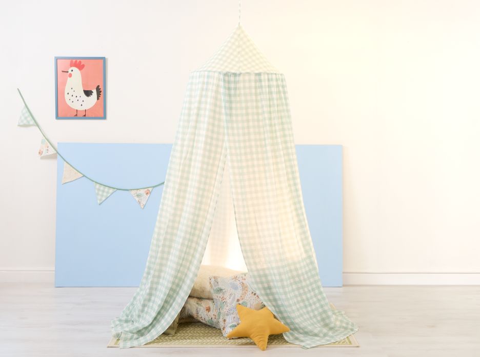 Good life children’s nursery canopy styled as a floor den with cushions and bunting, creating a calm, imaginative play corner.