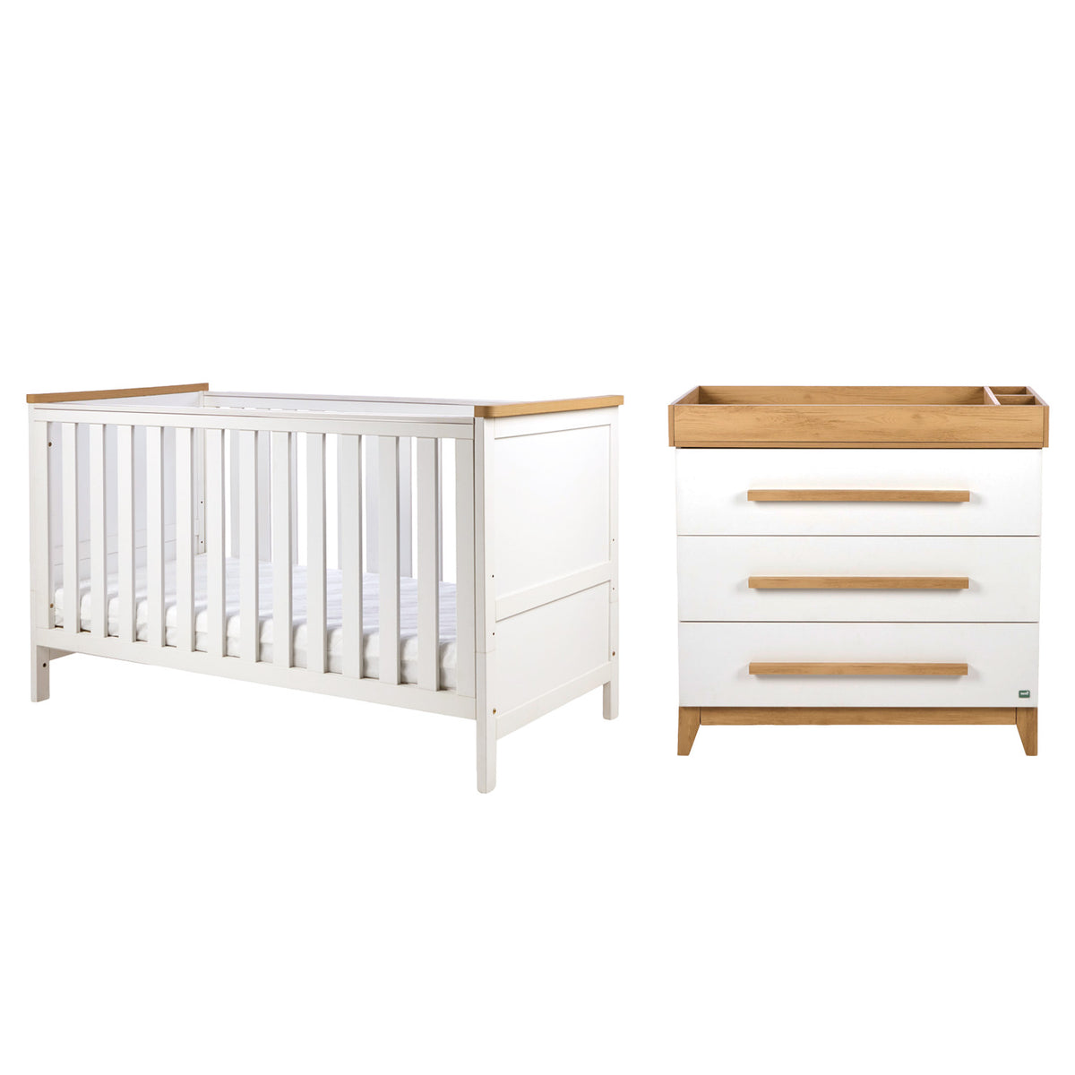 A white baby cot bed with natural golden oak wood trim and a matching three-drawer chest with a wooden changing tray, shown on a plain white background.