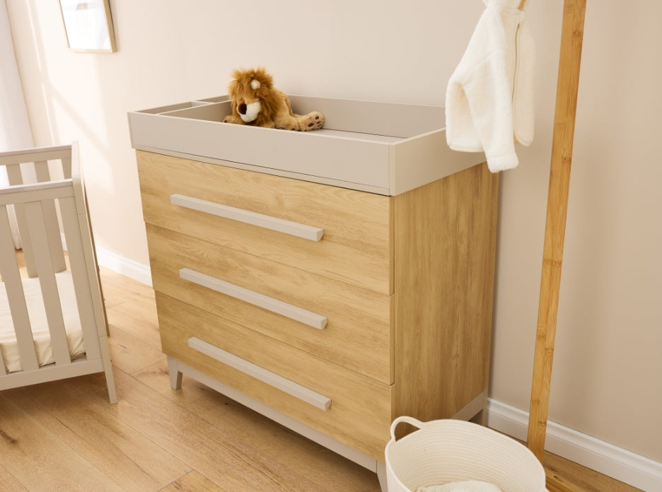 Hallee chest changer in mushroom and golden oak styled in nursery with cot and neutral décor.