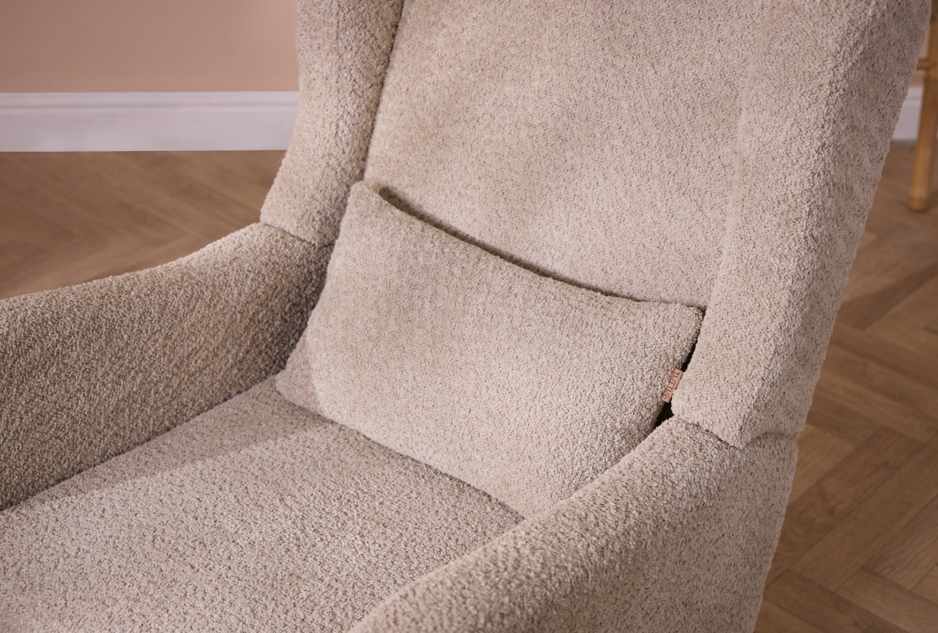 Close-up of Harper wingback rocking chair in mushroom showing soft boucle fabric, supportive back cushion and gently curved armrests.