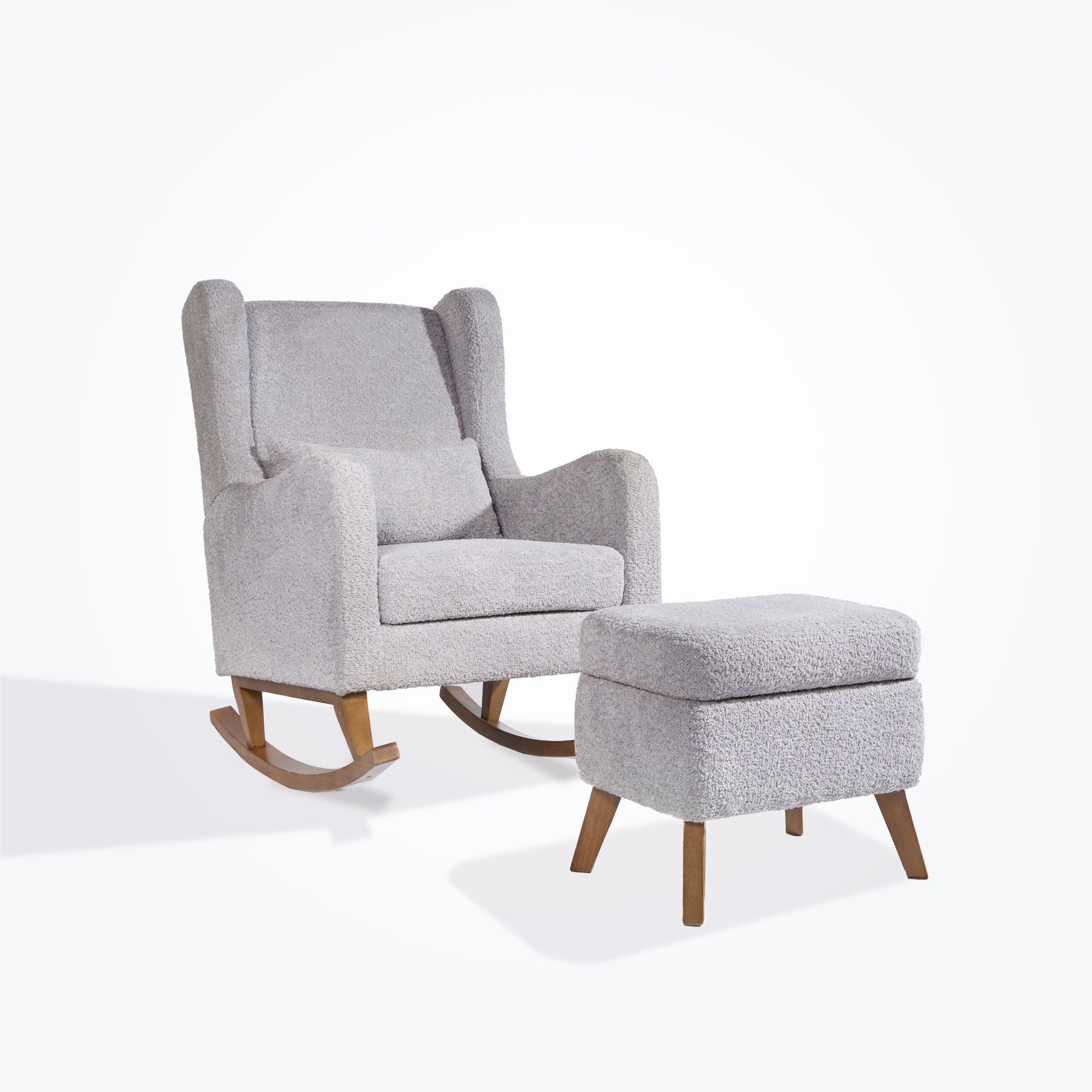 Angled cutout of the Harper Wingback chair and footstool in cloud grey boucle, showing deep cushioning and curved wooden legs.