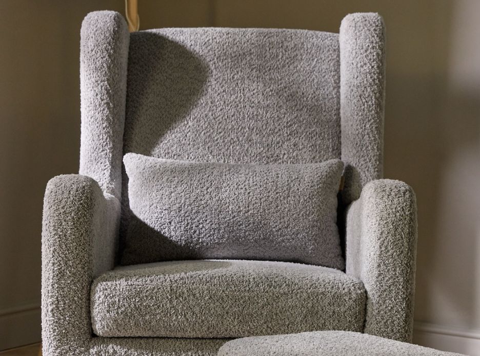 Front view of the Harper rocking chair and footstool in boucle cloud grey, highlighting the wingback design and lumbar cushion.