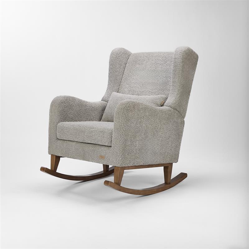 Angled view of the Harper Wingback rocking chair in cloud grey, with sculpted arms, soft boucle fabric and oak-finish rocking base.