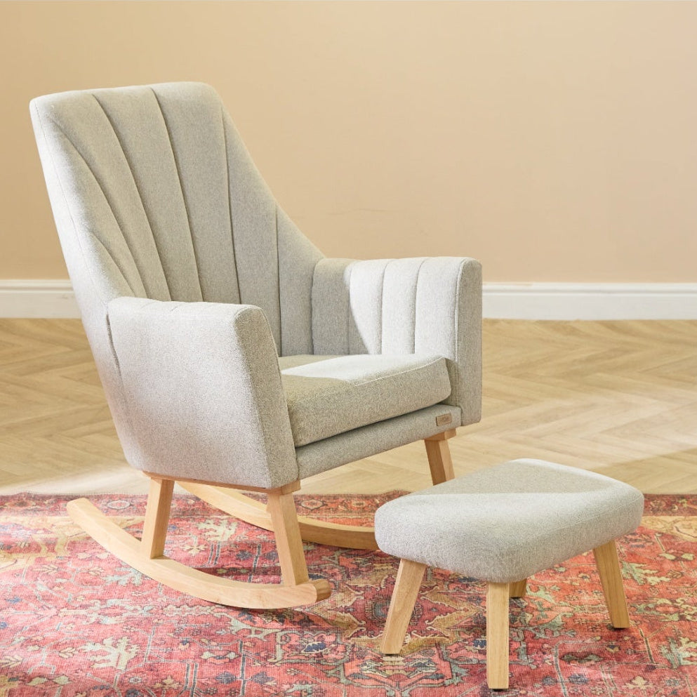 Lifestyle view of the Jonah rocking chair and footstool in stone, showing its supportive seat, smooth rocking base and cosy corner setup.