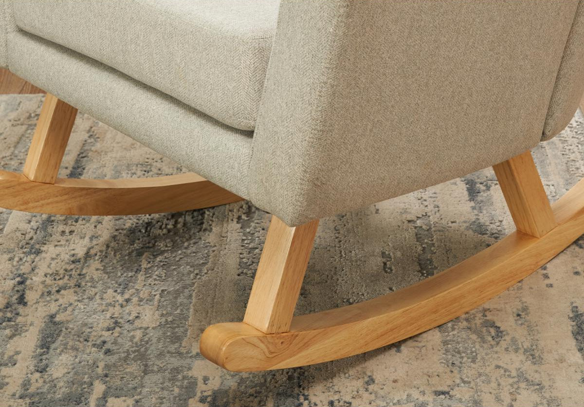 Details of the Jonah nursing chair legs in oak on a blue and beige rug