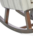 A close up of the Juno rocking chair rocking frame base in cashmere vintage stripe and walnut in a white background.