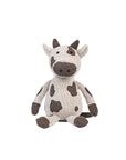 Plush Clemi cow toy sitting on a white background.