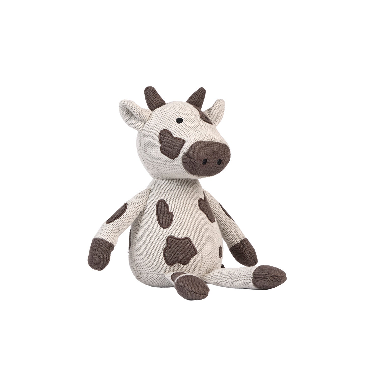 Plush cow toy on a white background.
