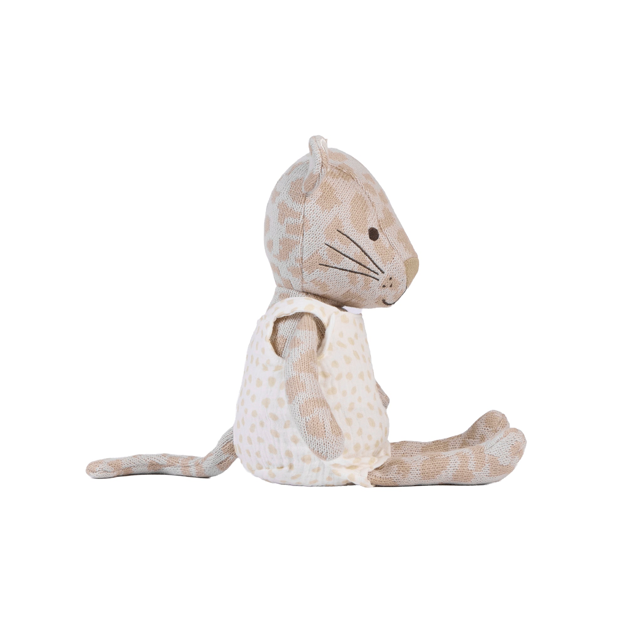 A plush stuffed animal shaped like a seated leopard, shown from the side on a plain white background. The toy has a cream and beige spotted pattern with embroidered facial details.