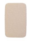 A bedside crib fitted sheets with a leopard inspired print, on a white background