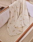 Patterned blanket from the Love Cats collection, draped over the CoZee bedside crib with a neutral background