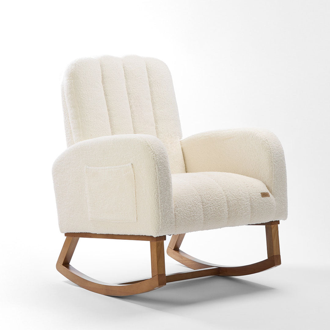 Angle view of the Luca nursing chair in cream showcasing a rounded silhouette, side pockets and rubberwood runners in a white background.