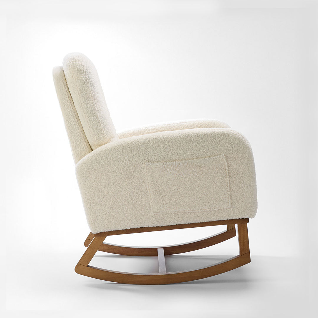 Side view of the Luca nursing chair in cream showcasing a rounded silhouette, side pockets and rubberwood runners in a white background.