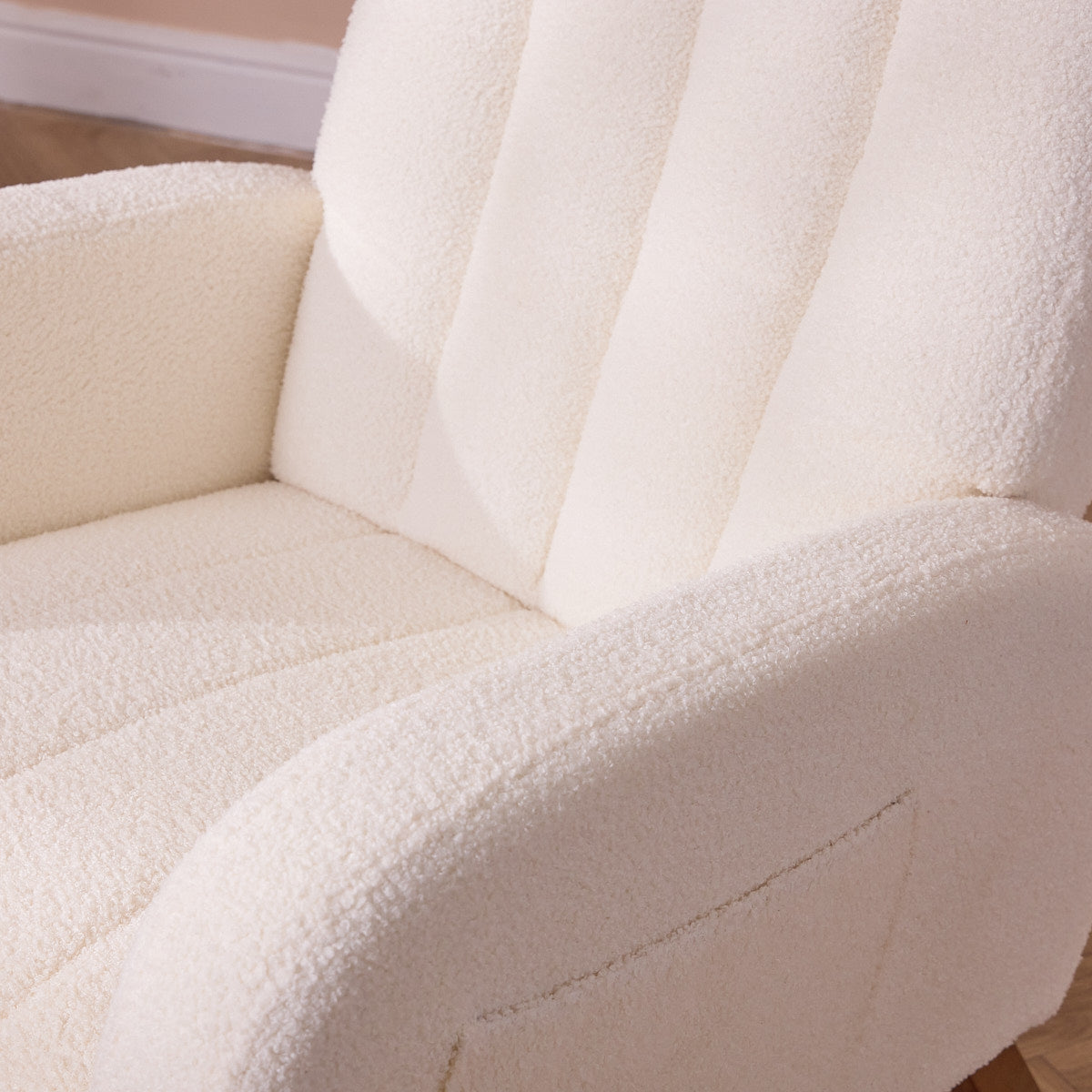 Close-up of the textured Lua nursing chair in cream with a blurred background